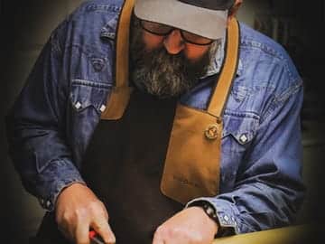 Paul Dufour sanding nodes on a culm of bamboo.