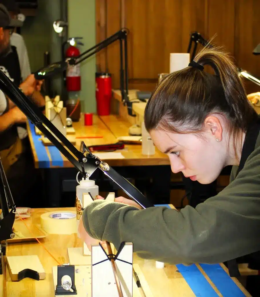 A focused young rod building student