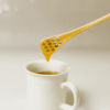 Flat bamboo honey dip stick into tea