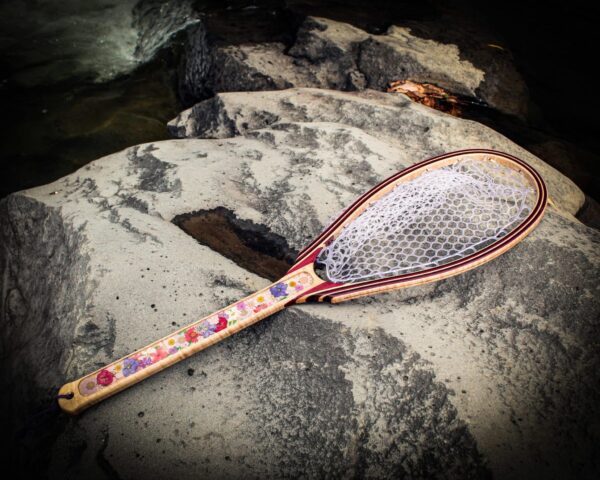 dried flower fishing net on a rock