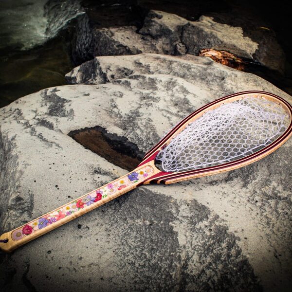 dried flower fishing net on a rock