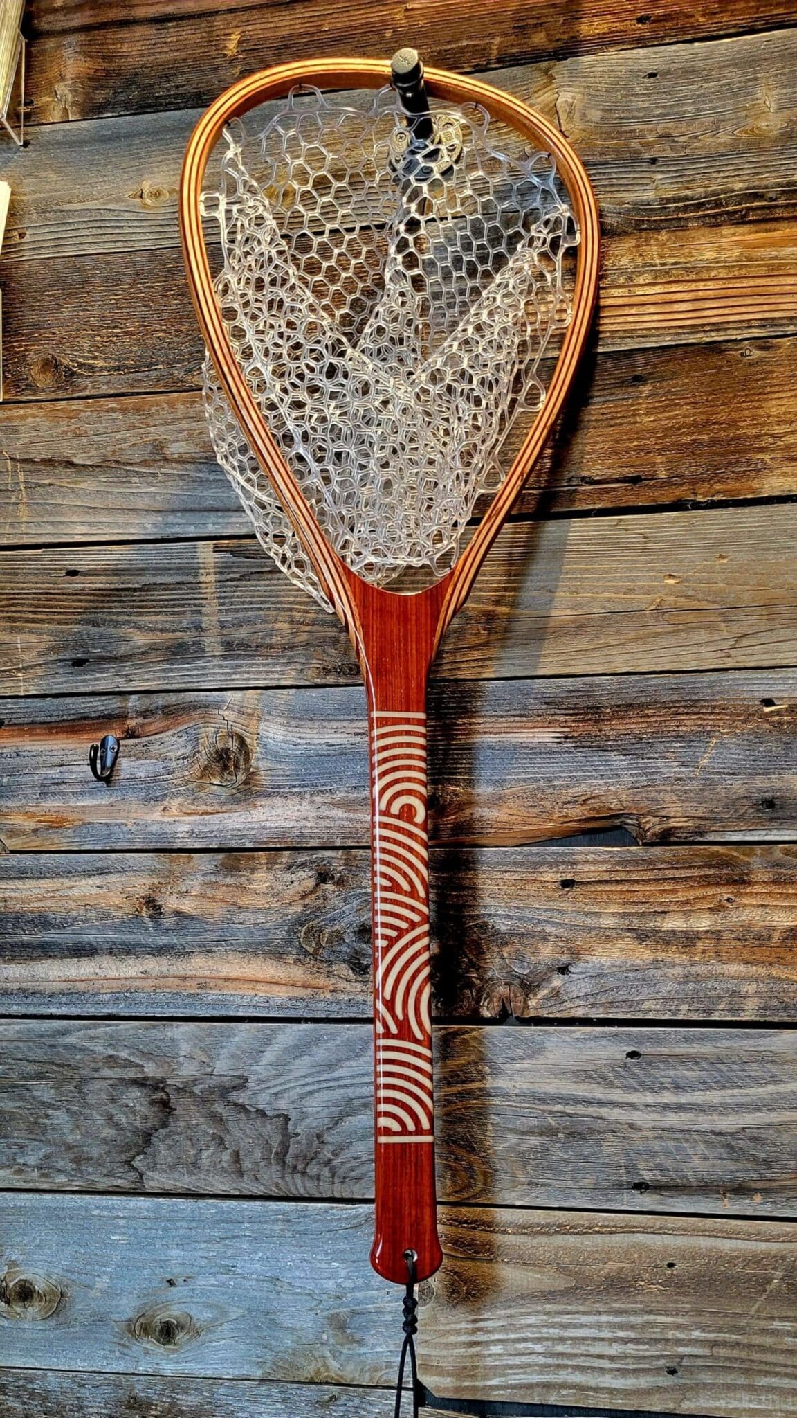 Mother of pearl geometric pattern in a Paduk wood landing net.