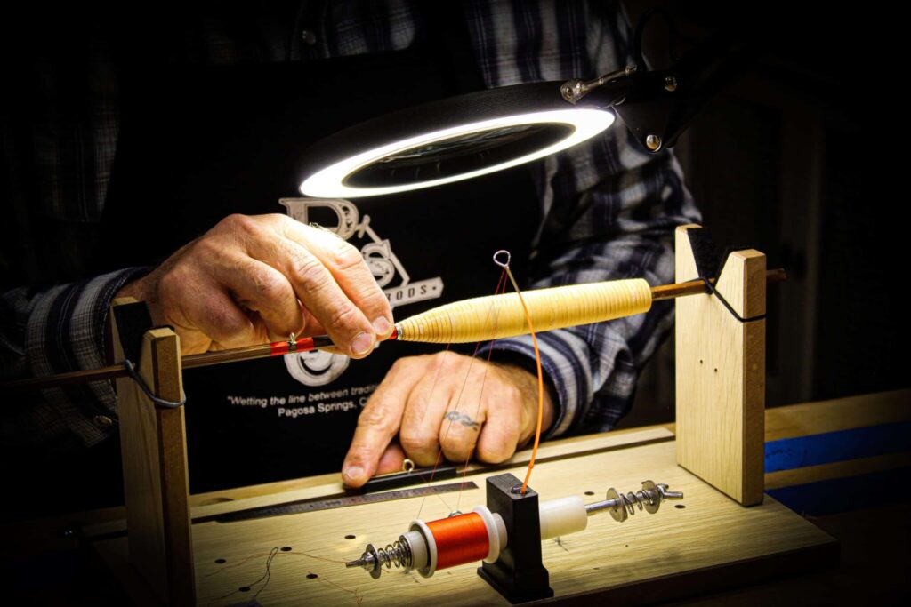 Hand wrapping silk on a bamboo fly rod.