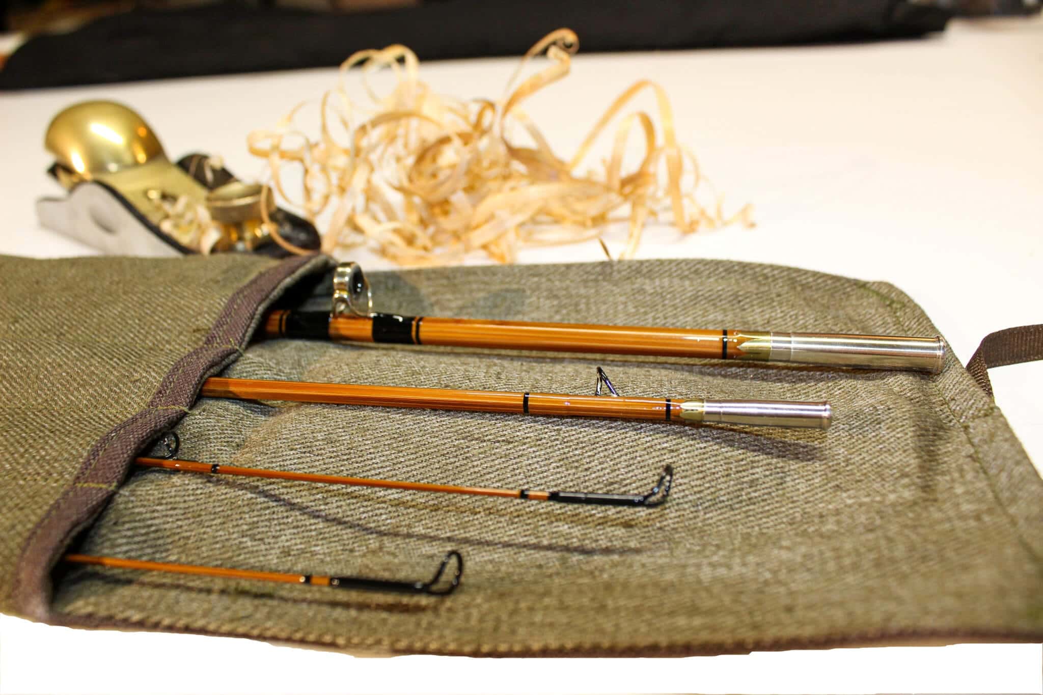 Bamboo fly rod in a rod sock with bamboo shavings from a handplaner